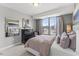 Comfortable bedroom with gray walls, a large window, and stylish decor at 404 Gaston Park Ln # 100, Wake Forest, NC 27587