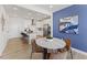 Cozy dining area with elegant round table adjacent to a modern, white kitchen at 404 Gaston Park Ln # 100, Wake Forest, NC 27587