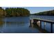 Picturesque lake view with a pier extending into the calm water and lush surrounding greenery at 404 Gaston Park Ln # 100, Wake Forest, NC 27587