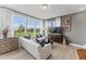Sun-lit living room features hardwood floors, stylish furniture, and scenic outdoor views at 404 Gaston Park Ln # 100, Wake Forest, NC 27587
