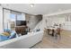 Bright, open-concept living room with a comfortable sofa, dining area, and modern kitchen at 404 Gaston Park Ln # 100, Wake Forest, NC 27587