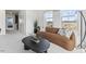 Modern living room showcasing a brown sofa, black coffee table, and a view of the outdoors at 404 Gaston Park Ln # 100, Wake Forest, NC 27587