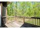 Wooden back porch overlooking a picturesque wooded area, perfect for outdoor enjoyment at 4057 Mackenzie Dr, Haw River, NC 27258