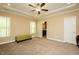 Neutral bedroom with carpet, windows, recessed lighting, and view to bath at 4057 Mackenzie Dr, Haw River, NC 27258
