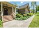 Beautiful stone house facade with brick stairs, a welcoming entrance, and lush landscaping enhancing curb appeal at 4057 Mackenzie Dr, Haw River, NC 27258