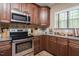 Bright kitchen featuring stainless steel appliances, granite counters, ample cabinet space, and wood flooring at 4057 Mackenzie Dr, Haw River, NC 27258