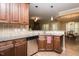 Stylish kitchen with stainless steel appliances, granite countertops, and wooden cabinets, open to adjacent dining at 4057 Mackenzie Dr, Haw River, NC 27258