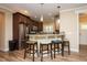 Modern kitchen with stainless steel appliances, granite countertops, bar seating and wood flooring at 4057 Mackenzie Dr, Haw River, NC 27258