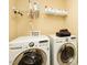 Well-lit laundry room with modern, front-loading washer and dryer and ample shelving at 4057 Mackenzie Dr, Haw River, NC 27258
