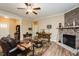 Cozy living room boasts a stone fireplace, comfortable seating, wood floors, and natural light at 4057 Mackenzie Dr, Haw River, NC 27258