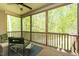 Relaxing screened porch with ceiling fan and beautiful view of the wooded backyard at 4057 Mackenzie Dr, Haw River, NC 27258