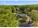 Aerial shot of a home nestled amongst a canopy of mature trees at 410 Long Ave, Roxboro, NC 27573