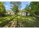 Large backyard featuring a storage shed and shade trees at 410 Long Ave, Roxboro, NC 27573