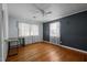 Cozy bedroom featuring hardwood floors, two windows with lots of light and a ceiling fan at 410 Long Ave, Roxboro, NC 27573