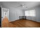 Bedroom with hardwood floors, closet space, and natural light from windows at 410 Long Ave, Roxboro, NC 27573
