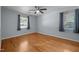 A well-lit bedroom features hardwood floors and a ceiling fan at 410 Long Ave, Roxboro, NC 27573