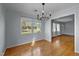 This bright dining room offers gleaming hardwood floors and serene views of the outdoors at 410 Long Ave, Roxboro, NC 27573
