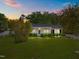 Beautiful single-story home featuring a lush green lawn and mature trees at 410 Long Ave, Roxboro, NC 27573
