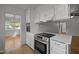 Well-appointed kitchen with stainless steel oven, white cabinets, and durable countertops at 410 Long Ave, Roxboro, NC 27573