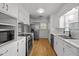 Bright kitchen with white cabinetry, stainless steel appliances, and durable flooring at 410 Long Ave, Roxboro, NC 27573