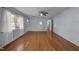 Sunlit living room with hardwood floors and neutral paint at 410 Long Ave, Roxboro, NC 27573
