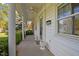 Inviting covered front porch with white columns and decorative planters at 410 Long Ave, Roxboro, NC 27573