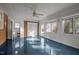 A bright sunroom features blue floors and natural light at 410 Long Ave, Roxboro, NC 27573
