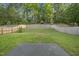 Wide backyard features a retaining wall, new fence, and grassy area at 413 Weeping Willow Dr, Durham, NC 27704