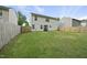 Spacious backyard features a new fence and an exterior view of the home at 413 Weeping Willow Dr, Durham, NC 27704