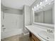 Bright bathroom featuring vanity, toilet, and a shower/bathtub combo at 413 Weeping Willow Dr, Durham, NC 27704