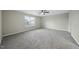 Large bedroom with neutral walls, a window, and plush carpeting at 413 Weeping Willow Dr, Durham, NC 27704