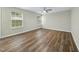 Bright bedroom featuring hardwood floors, neutral walls, and a ceiling fan at 413 Weeping Willow Dr, Durham, NC 27704