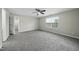 Spacious bedroom with plush carpeting, ceiling fan, and natural light at 413 Weeping Willow Dr, Durham, NC 27704