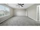 Spacious bedroom featuring soft carpeting and a ceiling fan at 413 Weeping Willow Dr, Durham, NC 27704