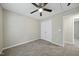 Neutral bedroom features gray carpet, ceiling fan and large closet at 413 Weeping Willow Dr, Durham, NC 27704