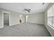 Large bedroom with a window and multiple doors leading to other rooms at 413 Weeping Willow Dr, Durham, NC 27704