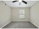 Bedroom with neutral walls, ceiling fan, and window at 413 Weeping Willow Dr, Durham, NC 27704