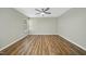 A bright bedroom features hardwood floors, neutral walls, and a ceiling fan at 413 Weeping Willow Dr, Durham, NC 27704