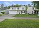 Inviting two-story home featuring a well-manicured front lawn and attached garage at 413 Weeping Willow Dr, Durham, NC 27704