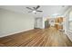 A bright open-concept living area with hardwood floors and neutral walls and a ceiling fan at 413 Weeping Willow Dr, Durham, NC 27704