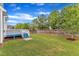 Expansive backyard with a deck, lush green lawn, and a privacy fence, perfect for outdoor activities at 4252 Rockdell Hall St, Raleigh, NC 27616