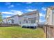 Exterior view of a house showing the backyard with a lawn, deck, and privacy fence, perfect for relaxation and recreation at 4252 Rockdell Hall St, Raleigh, NC 27616