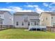 Backyard featuring a well-maintained lawn, deck, and fence, offering a private and serene outdoor space at 4252 Rockdell Hall St, Raleigh, NC 27616