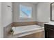 The primary ensuite bath includes a soaking tub with tile surround and a window at 4252 Rockdell Hall St, Raleigh, NC 27616