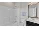 Full bathtub and vanity combination in a well-lit bathroom at 4252 Rockdell Hall St, Raleigh, NC 27616