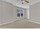 Comfortable bedroom featuring neutral carpet, ceiling fan, and natural light at 4252 Rockdell Hall St, Raleigh, NC 27616