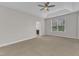 Carpeted bedroom with a trey ceiling with ceiling fan and an ensuite bathroom at 4252 Rockdell Hall St, Raleigh, NC 27616