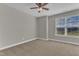 Neutral bedroom has a ceiling fan and a bright window at 4252 Rockdell Hall St, Raleigh, NC 27616