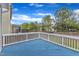 Inviting outdoor deck featuring a blue painted floor and white railings, perfect for relaxing or entertaining at 4252 Rockdell Hall St, Raleigh, NC 27616