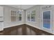 Bright dining area with hardwood floors, large windows, and access to the outdoors at 4252 Rockdell Hall St, Raleigh, NC 27616